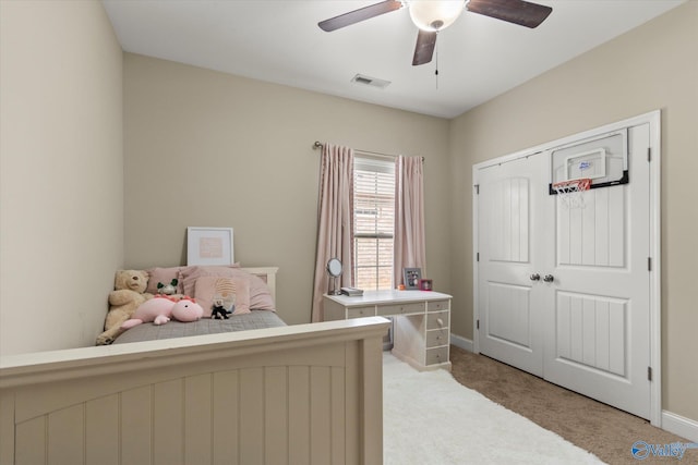 bedroom with ceiling fan, a closet, and light carpet