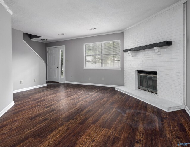 unfurnished living room with crown molding, wood-type flooring, a brick fireplace, and a textured ceiling