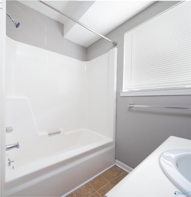 bathroom with shower / tub combination, tile patterned flooring, and sink