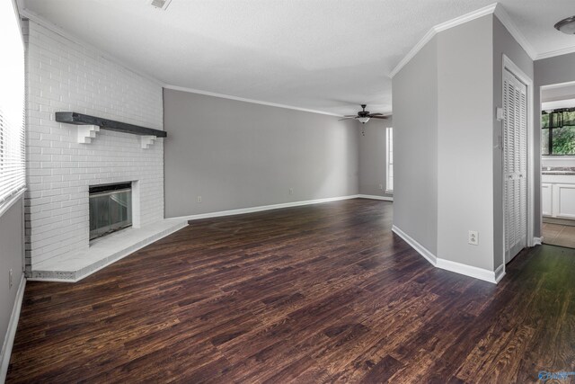 unfurnished living room featuring ceiling fan, a fireplace, wood-type flooring, and ornamental molding