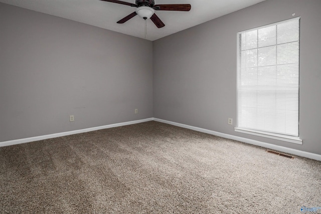 carpeted spare room featuring ceiling fan