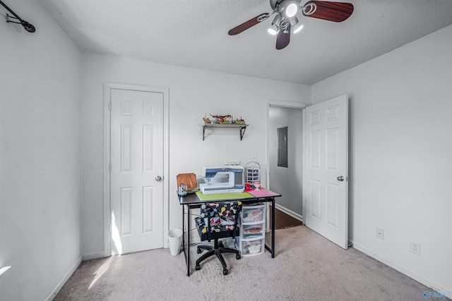 carpeted office featuring ceiling fan, electric panel, and a textured ceiling