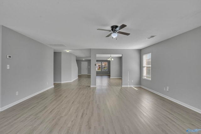 unfurnished living room featuring light hardwood / wood-style flooring and ceiling fan with notable chandelier