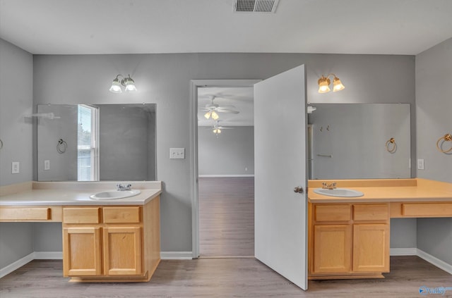 bathroom with vanity, hardwood / wood-style flooring, and ceiling fan