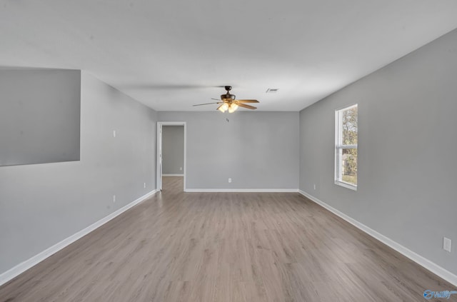 spare room with light hardwood / wood-style flooring and ceiling fan