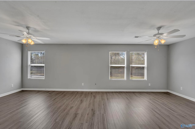 empty room with dark wood-type flooring and ceiling fan