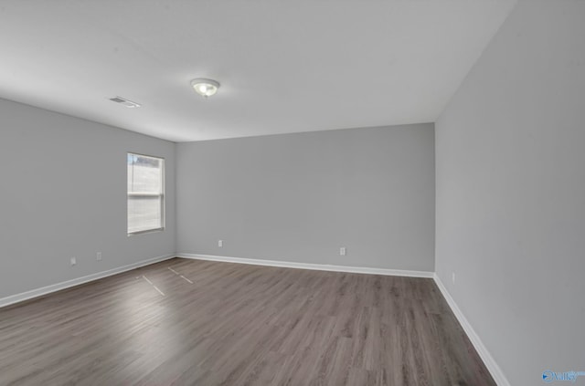 unfurnished room featuring hardwood / wood-style floors