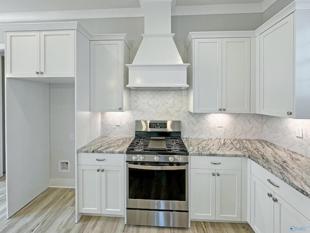 kitchen featuring premium range hood, white cabinetry, and stainless steel range with gas stovetop