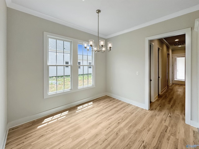 unfurnished dining area with light hardwood / wood-style floors, crown molding, and an inviting chandelier