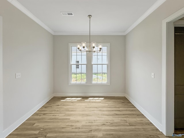 unfurnished dining area with a notable chandelier, ornamental molding, and light hardwood / wood-style floors