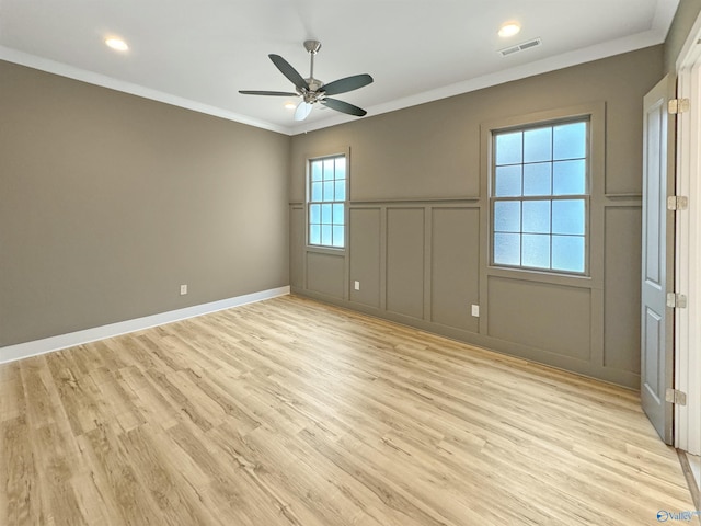 spare room featuring crown molding, ceiling fan, and light hardwood / wood-style floors