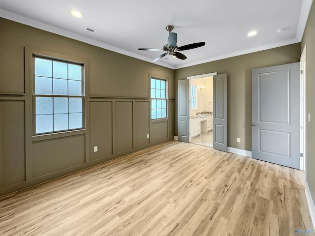 unfurnished bedroom featuring light hardwood / wood-style flooring, ornamental molding, ceiling fan, and ensuite bathroom