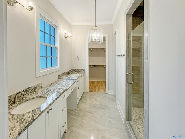 bathroom featuring ornamental molding, walk in shower, double sink vanity, and hardwood / wood-style floors