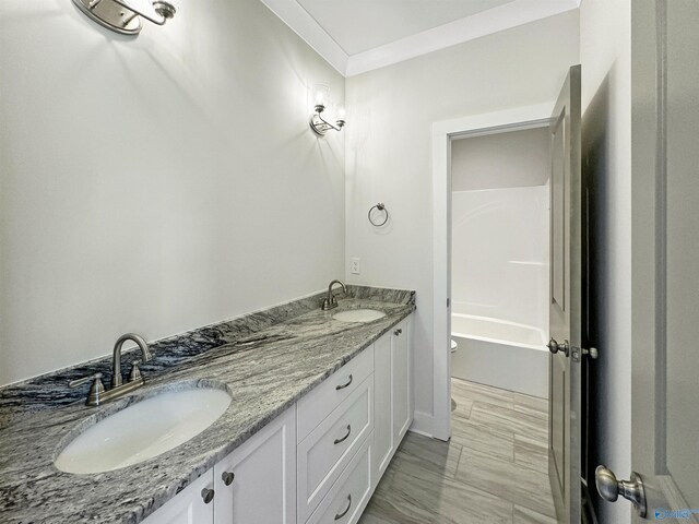 full bathroom featuring tub / shower combination, dual bowl vanity, toilet, tile patterned floors, and ornamental molding