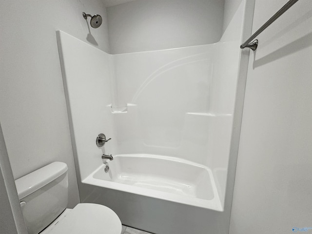 bathroom with washtub / shower combination and toilet