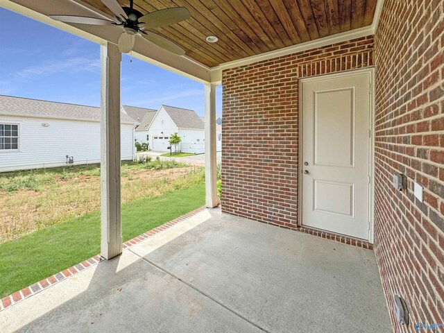 view of patio featuring a garage and ceiling fan