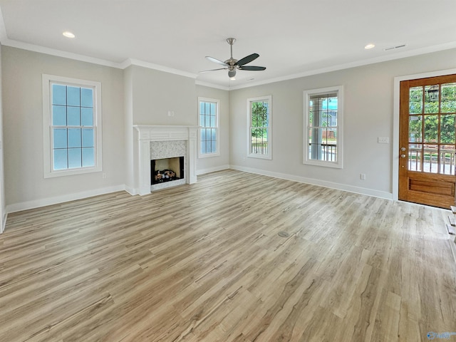 unfurnished living room featuring crown molding and light wood-type flooring