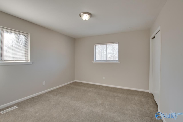 spare room with light colored carpet