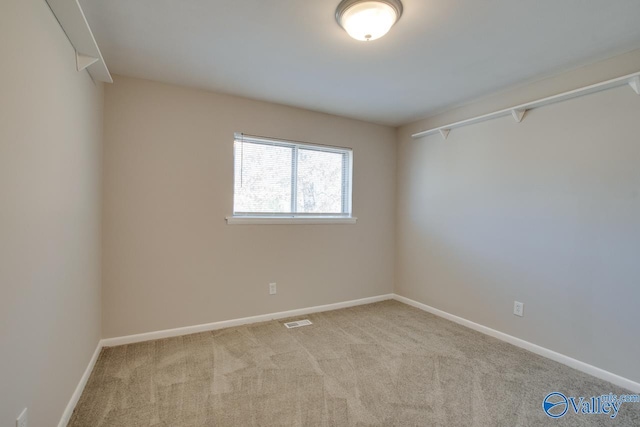 spare room featuring light colored carpet