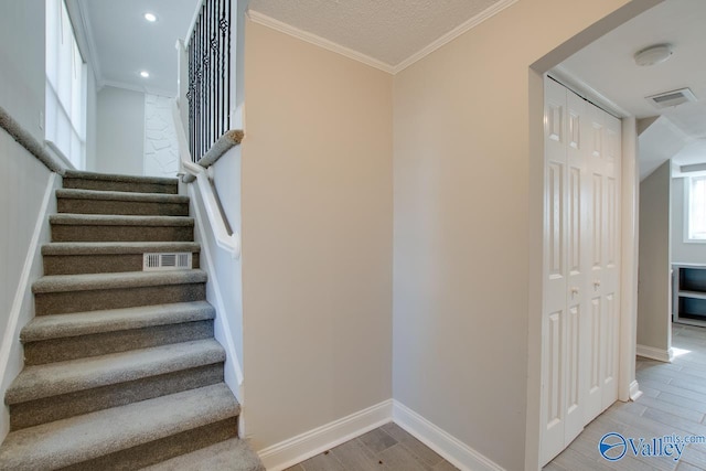 stairs featuring crown molding