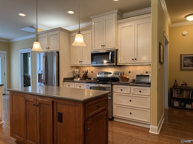 kitchen with a center island, tasteful backsplash, dark countertops, and appliances with stainless steel finishes