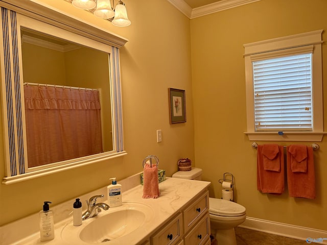 bathroom featuring toilet, vanity, crown molding, tile patterned flooring, and baseboards