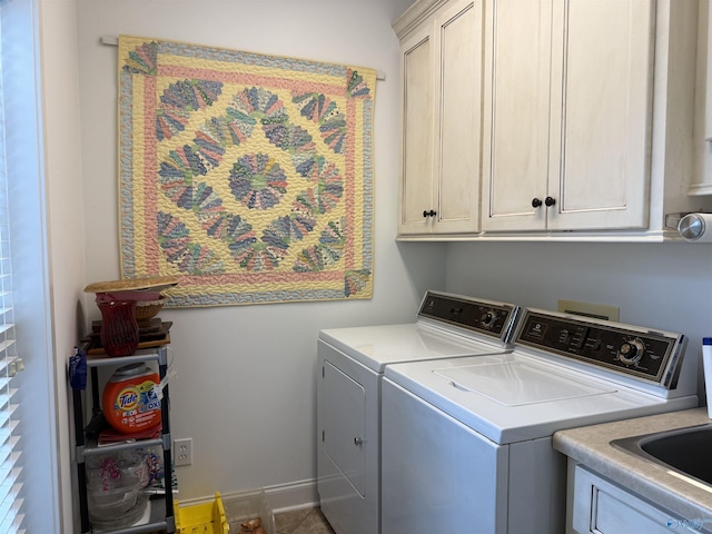 laundry room featuring washing machine and clothes dryer and cabinet space