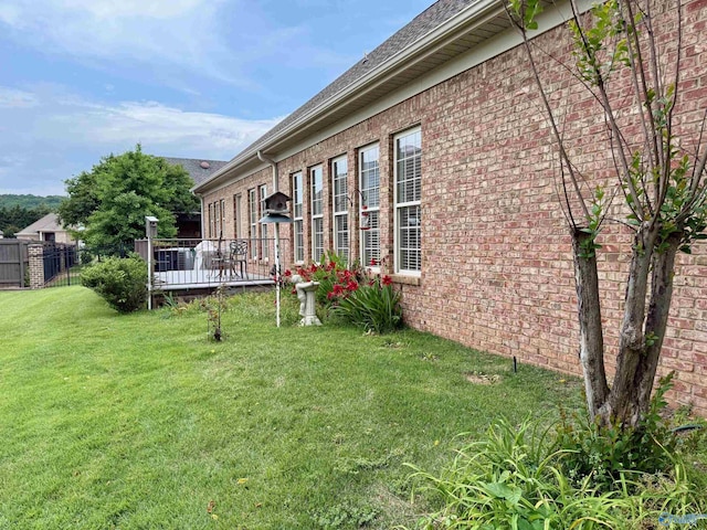 view of yard featuring fence and a deck