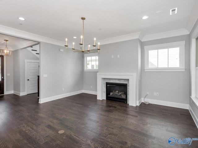 unfurnished living room featuring ornamental molding, a notable chandelier, and dark hardwood / wood-style flooring