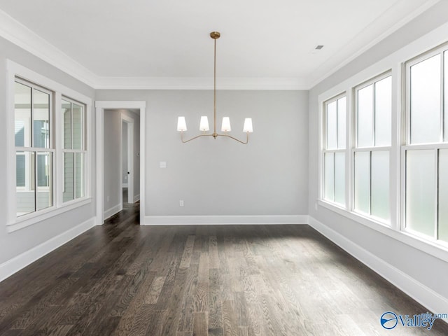 unfurnished dining area featuring ornamental molding, plenty of natural light, and a chandelier