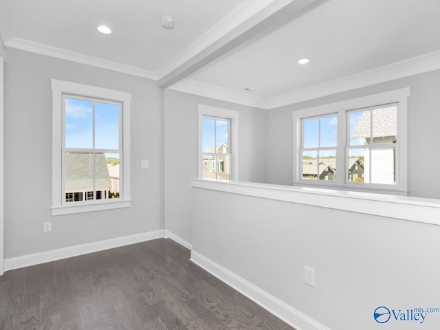 unfurnished room featuring ornamental molding, a healthy amount of sunlight, and dark hardwood / wood-style floors