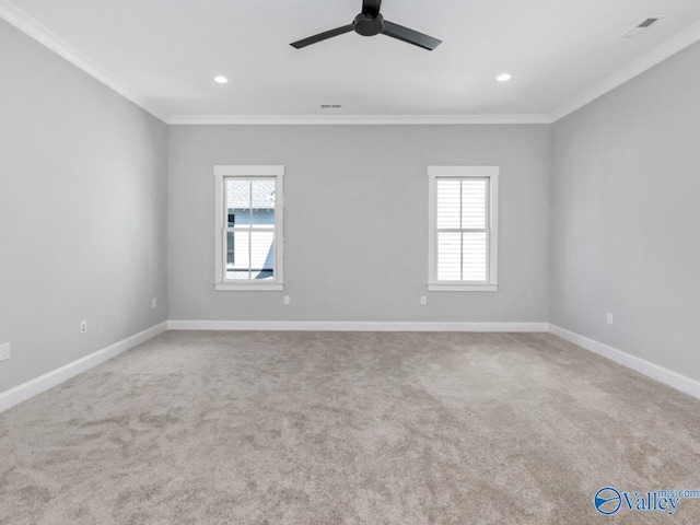 unfurnished room with carpet floors, crown molding, and plenty of natural light