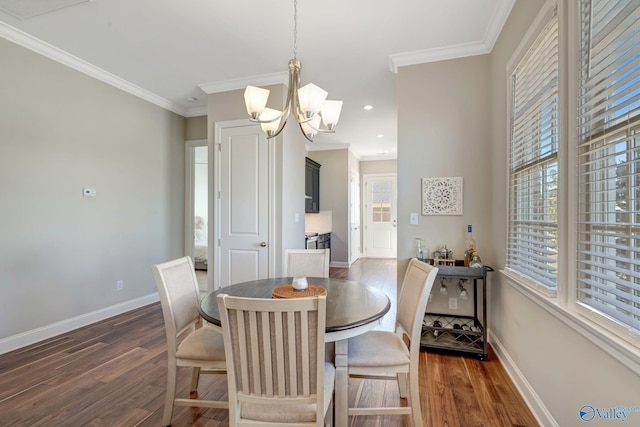 dining space featuring a chandelier, ornamental molding, and dark wood-style flooring