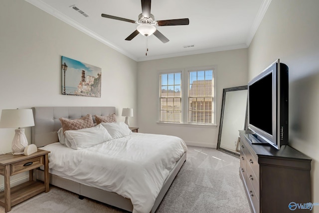 bedroom with visible vents, light colored carpet, crown molding, and baseboards