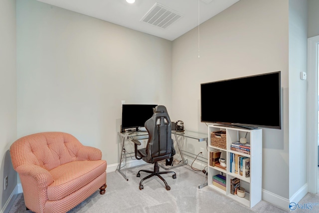 carpeted office space with visible vents, baseboards, and attic access