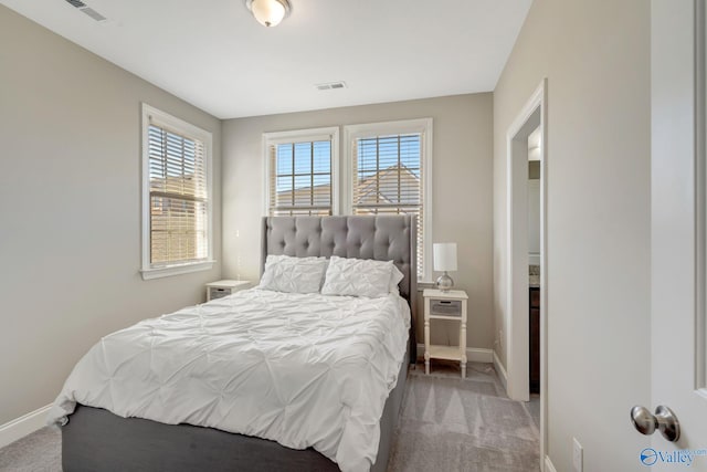 carpeted bedroom featuring visible vents and baseboards