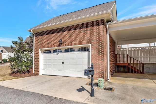 garage with driveway and fence