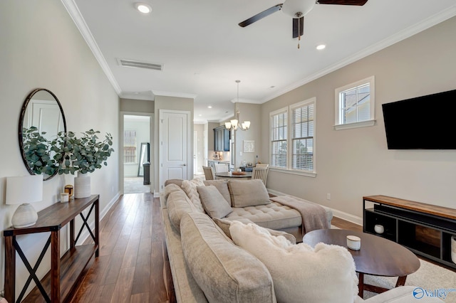 living area featuring visible vents, crown molding, dark wood-type flooring, baseboards, and recessed lighting