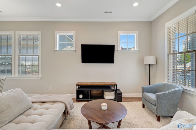 living area featuring crown molding, recessed lighting, wood finished floors, and baseboards