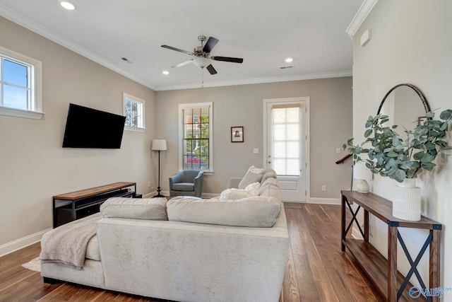 living area featuring dark wood-type flooring, baseboards, and ornamental molding