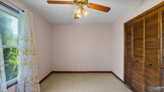 2302 Auburn Dr, Decatur, AL 35603 - unfurnished bedroom featuring a closet, baseboards, and a ceiling fan