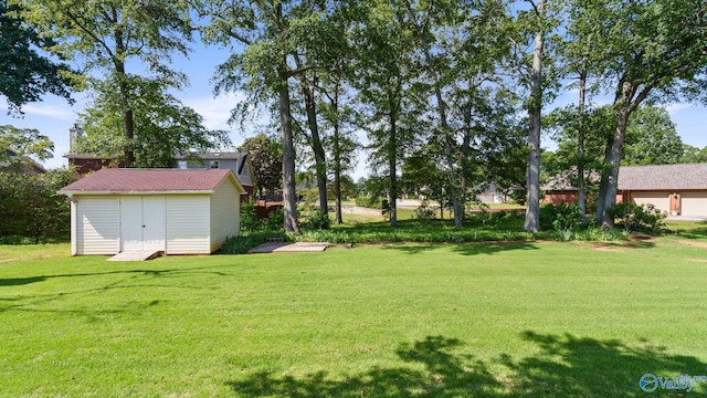 2302 Auburn Dr, Decatur, AL 35603 - view of grassy yard with a storage unit and an outdoor structure