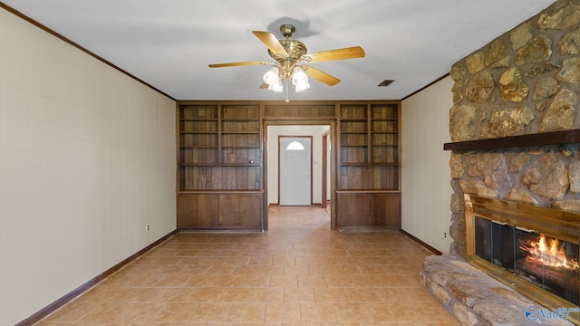 2302 Auburn Dr, Decatur, AL 35603 - unfurnished living room with built in features, a stone fireplace, ceiling fan, crown molding, and baseboards