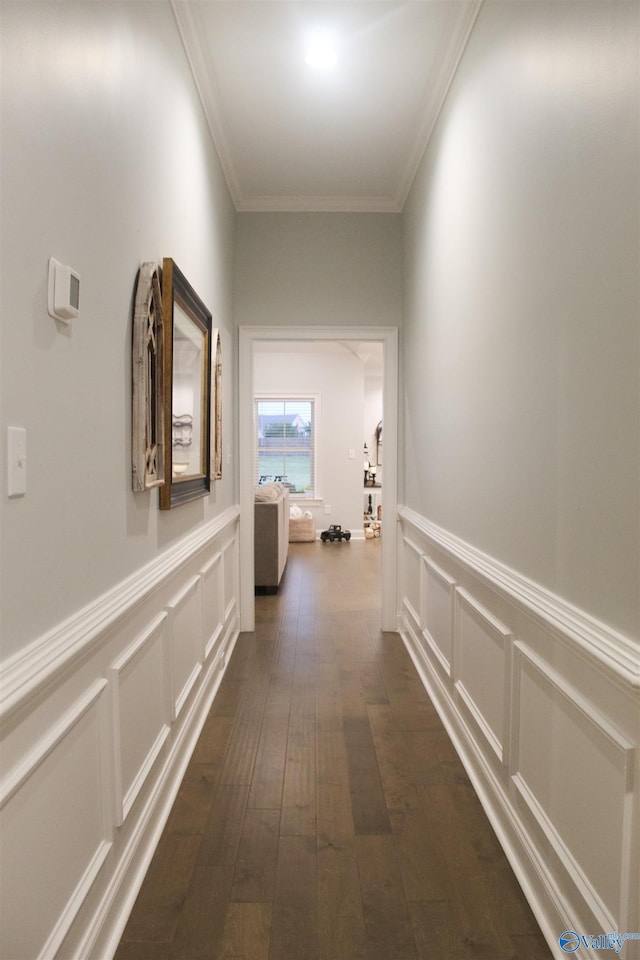 hall with dark hardwood / wood-style flooring and ornamental molding