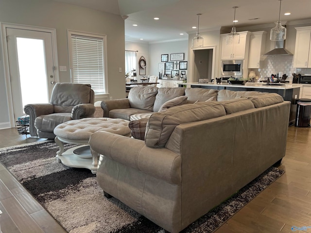 living room featuring wood-type flooring and ornamental molding