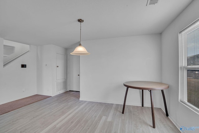 unfurnished dining area with light hardwood / wood-style floors