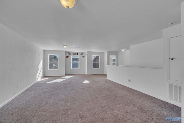 unfurnished living room featuring carpet