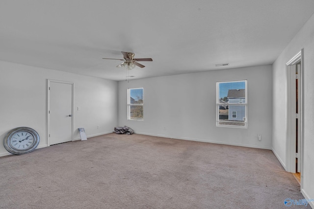 empty room featuring light carpet and ceiling fan