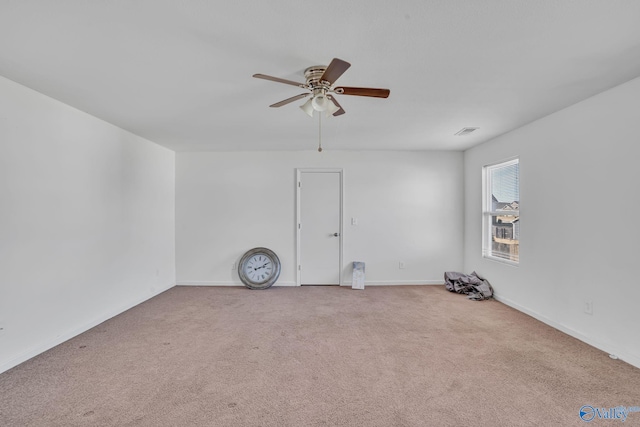 spare room featuring ceiling fan and light colored carpet