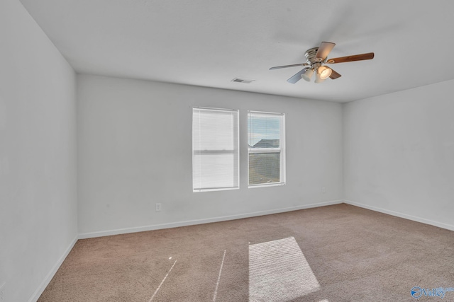 carpeted spare room with ceiling fan